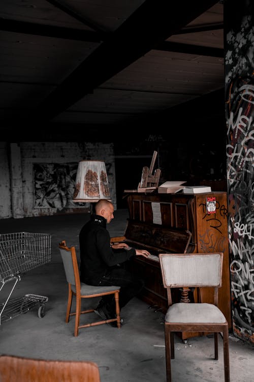 A Man Playing the Piano in an Abandoned Building