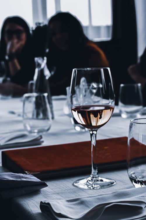 Free Fine wine in crystal clear wineglass on served table in light luxury restaurant Stock Photo