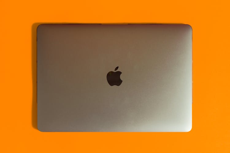 Silver MacBook On Yellow Surface