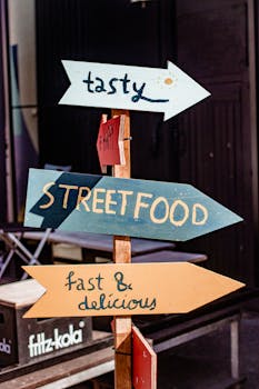 Vibrant street food sign in Riga, pointing to tasty and delicious options.