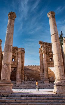Explore the stunning architectural ruins of ancient Jerash, capturing the grandeur of Roman columns.