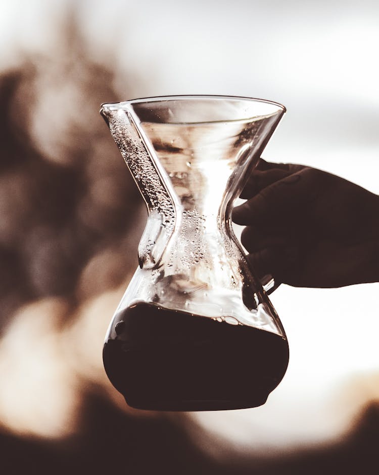 Photo Of A Person's Hand Holding A Glass Brewer