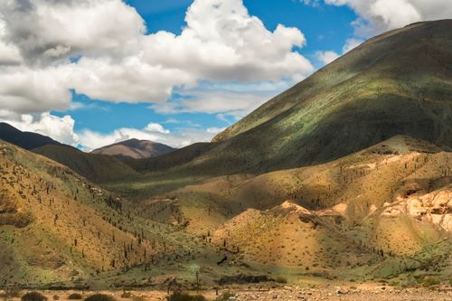 Free A breathtaking view of arid mountains under a vivid blue sky with clouds, capturing natural beauty. Stock Photo