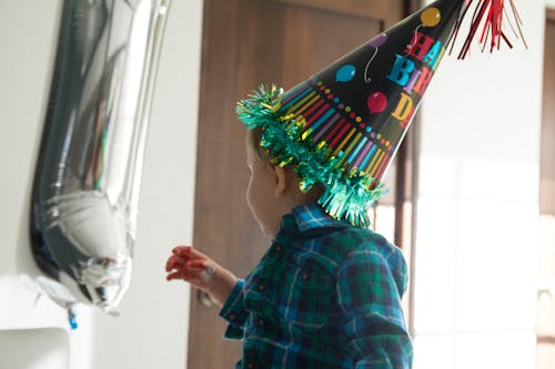 Free A Child Wearing a Party Hat Stock Photo