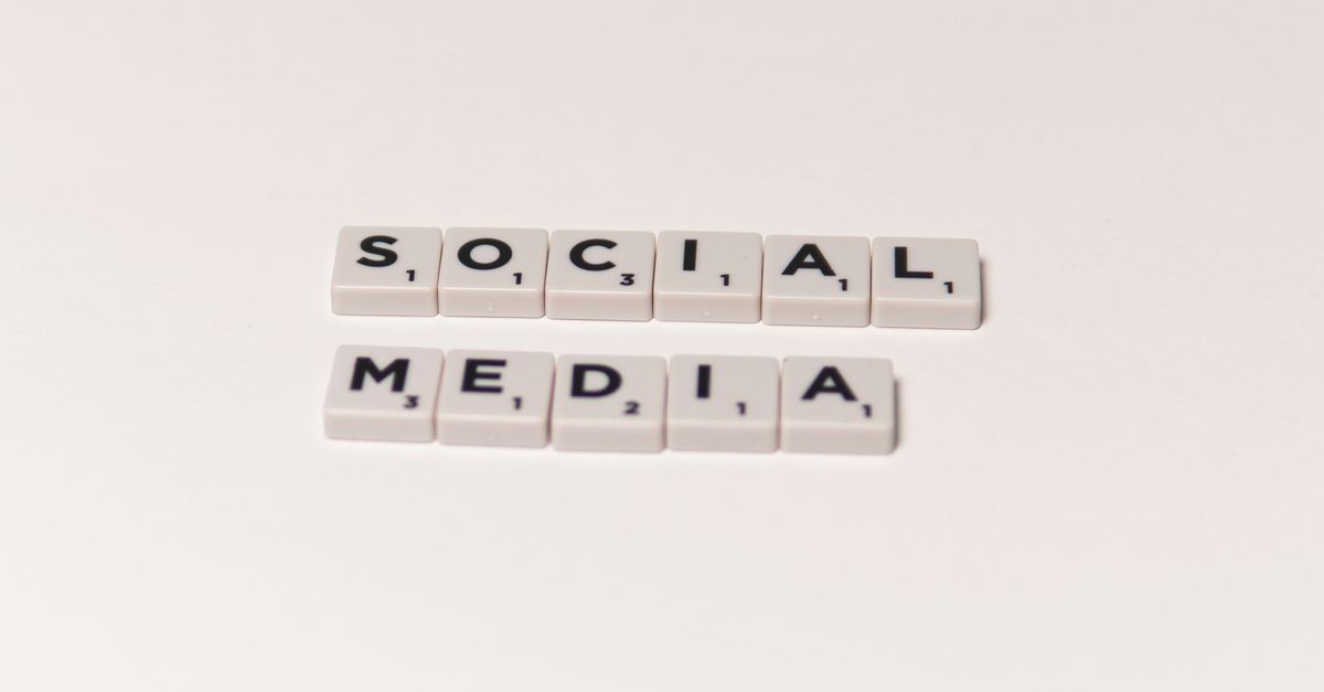 Scrabble tiles spelling 'social media' on a white background, representing digital communication concepts.