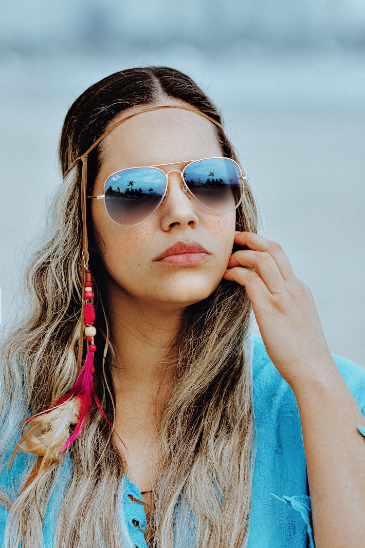 Woman In Blue Shirt Wearing Feather Headwear