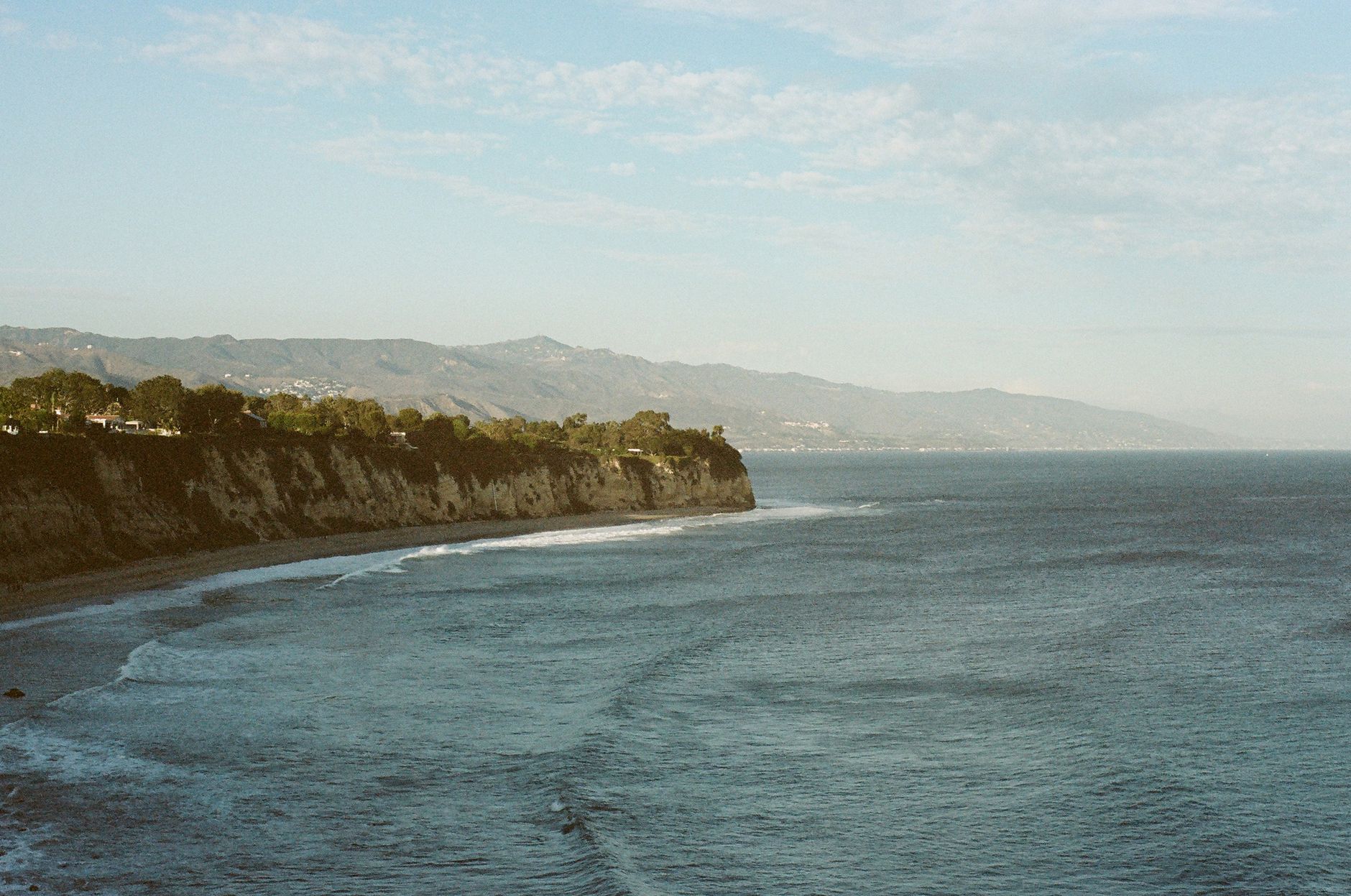 Malibu coastline at golden hour with the Pacific glowing amber