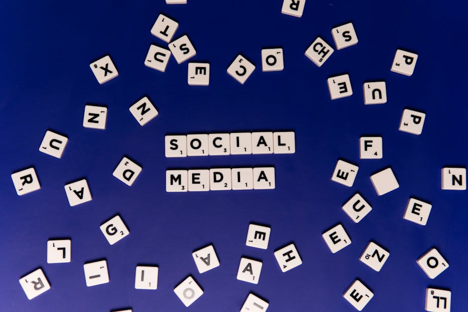 White Scrabble Blocks with Black Letters on Blue Surface