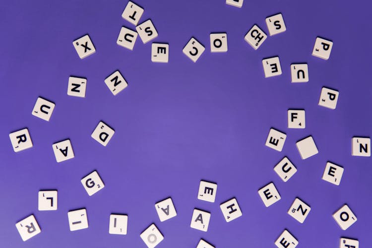 White Scrabble Blocks With Black Letters