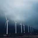 White Wind Turbines Under White Clouds