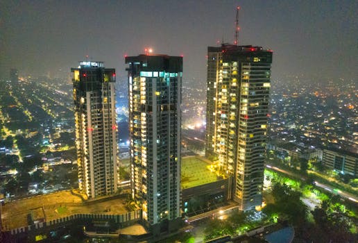 A breathtaking aerial view of illuminated skyscrapers in Jakarta at night, showcasing urban architecture.