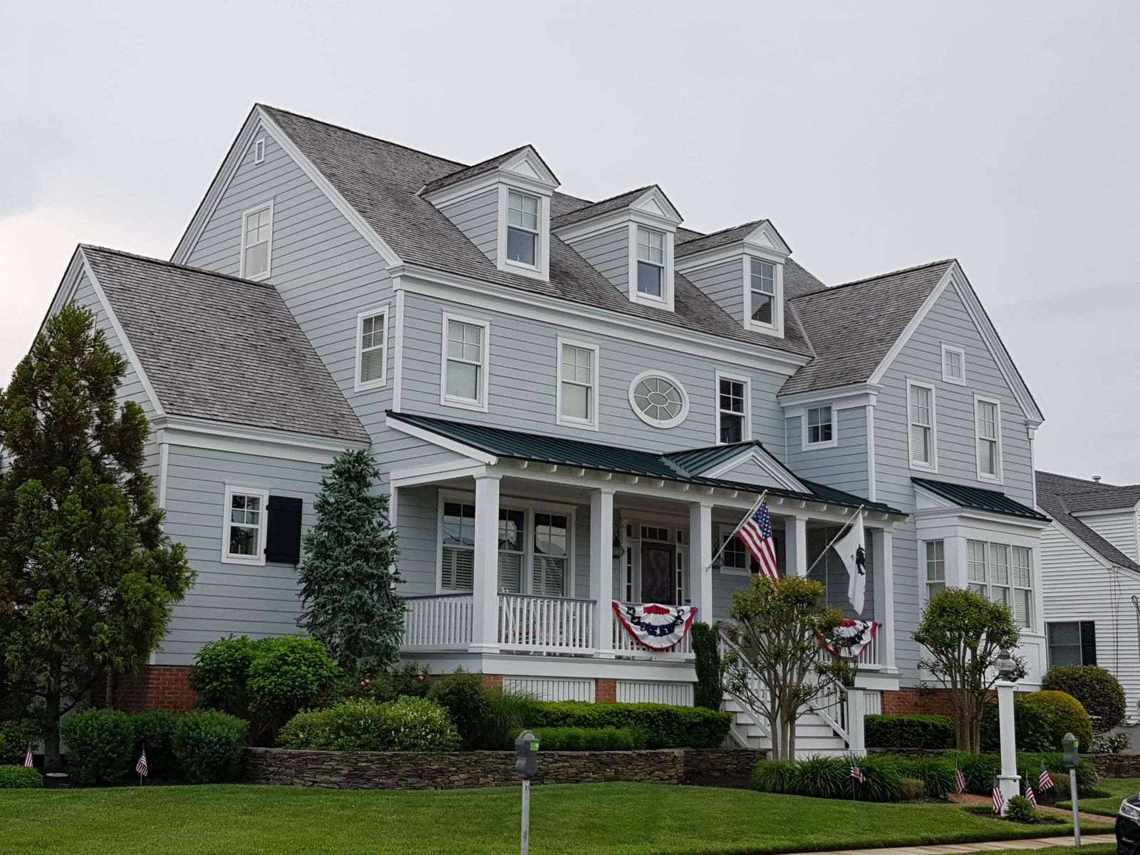 Two-story colonial-style home with blue and gray wooden siding and a manicured front lawn, Kimball Mill, Naperville IL