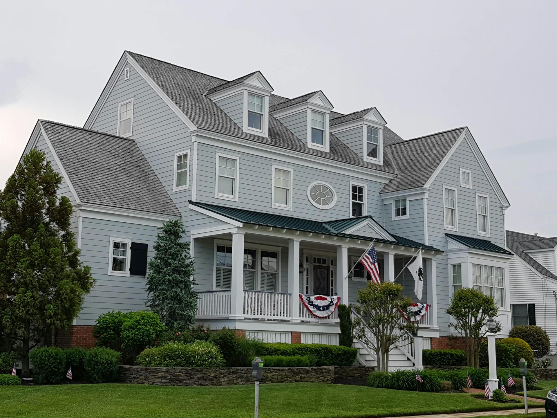 Blue and Gray Wooden House with Flags