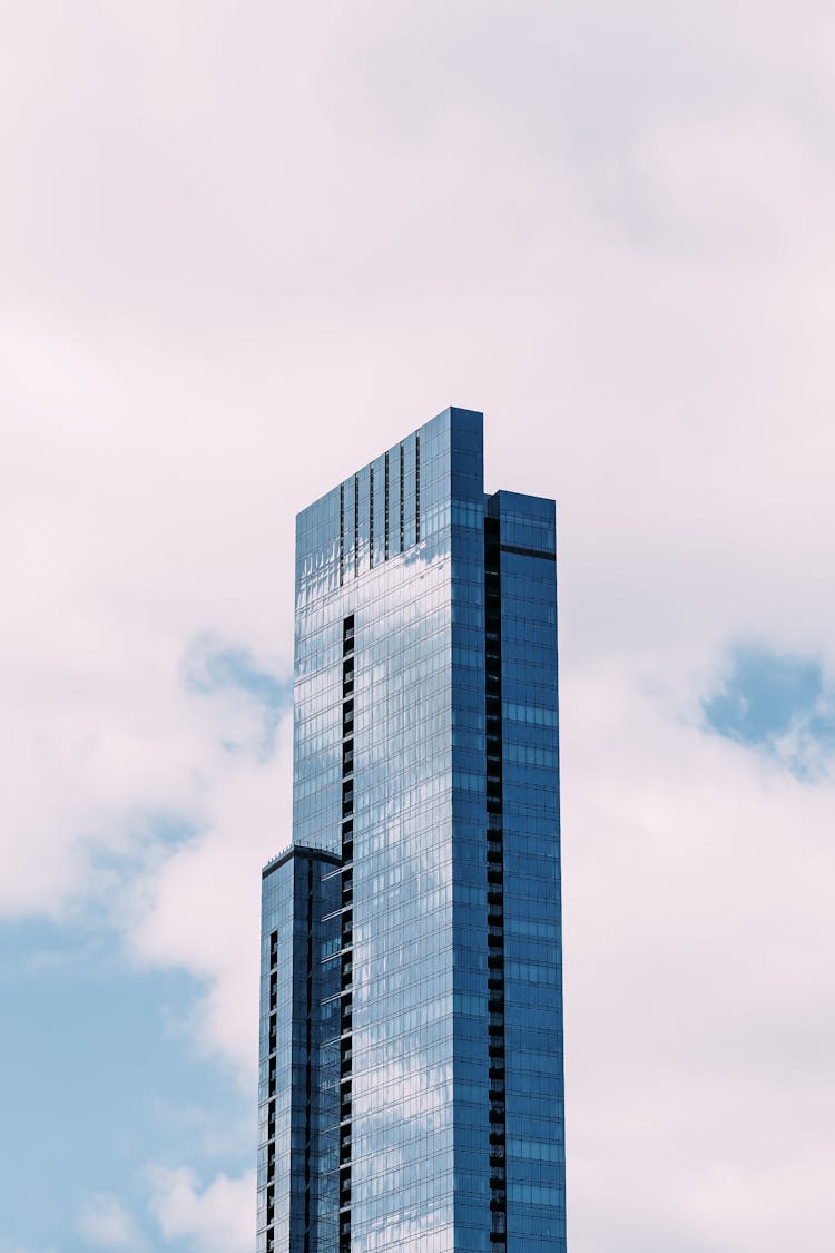 High Rise Glass Skyscraper Against Blue Sky