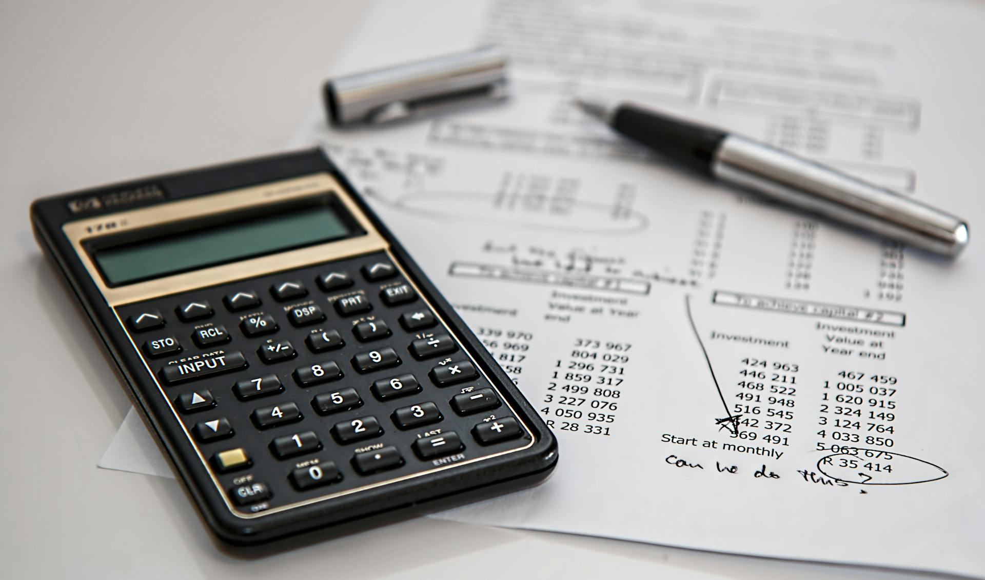 Free Black Calculator Near Ballpoint Pen on White Printed Paper Stock Photo