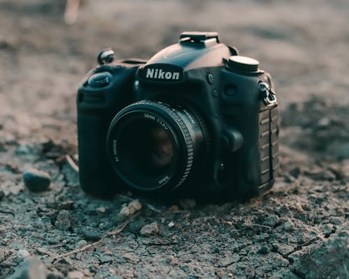 Free Black Nikon Dslr Camera on the Ground Stock Photo
