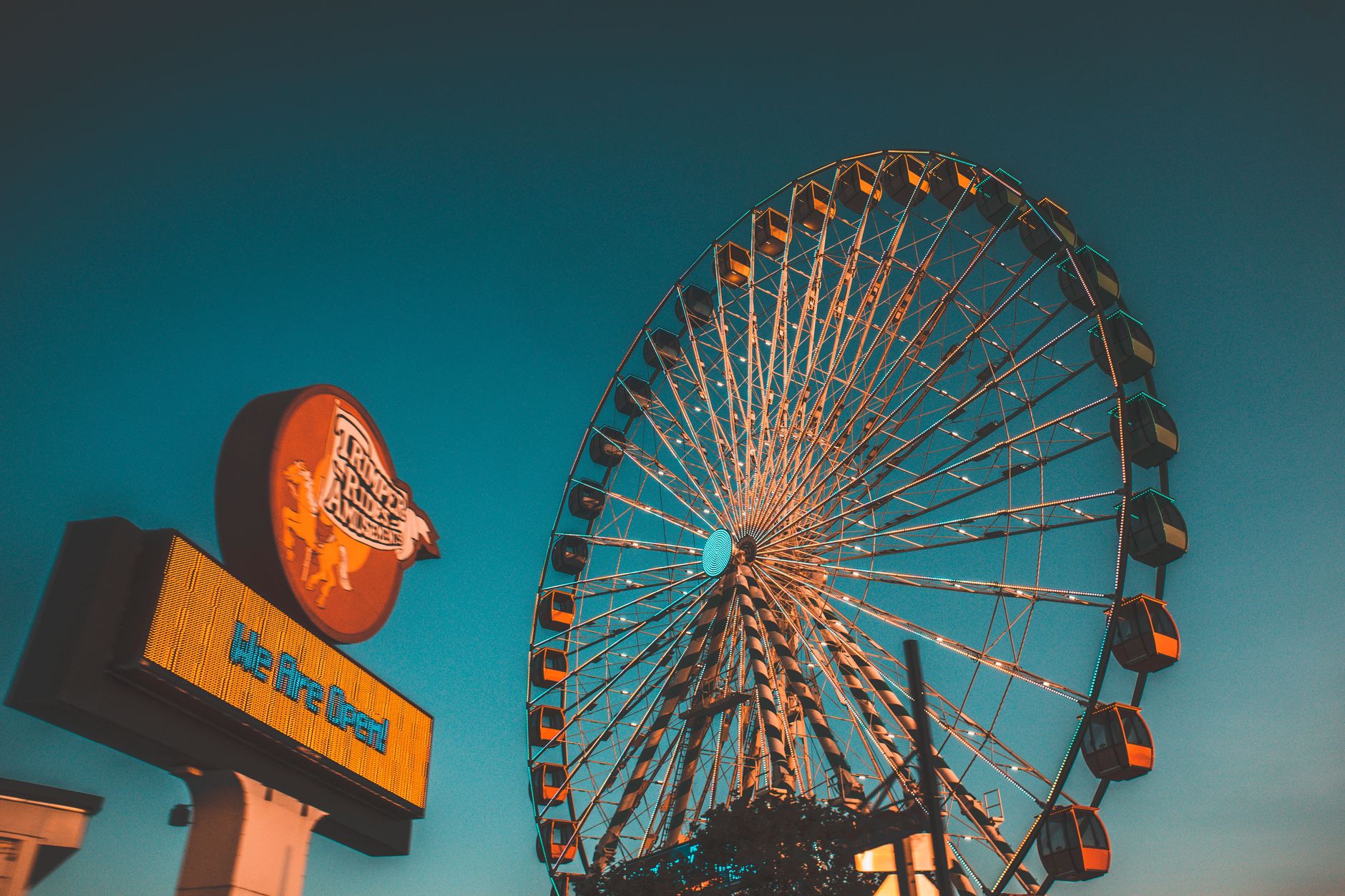 Colorful ferris wheel against a vibrant evening sky at Ocean City amusement park.