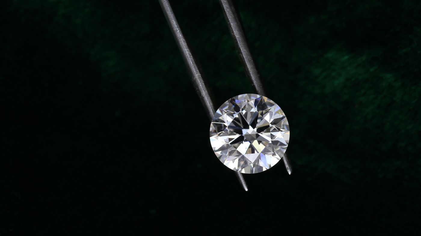 A single cut diamond photographed against a dark background