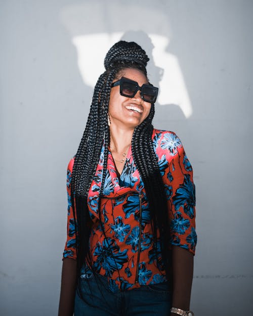 Photo of a Woman with Braids Wearing Black Sunglasses