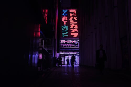 Photograph of People Near Neon Signages