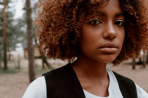 Young Woman with Curly Hair in the Forest