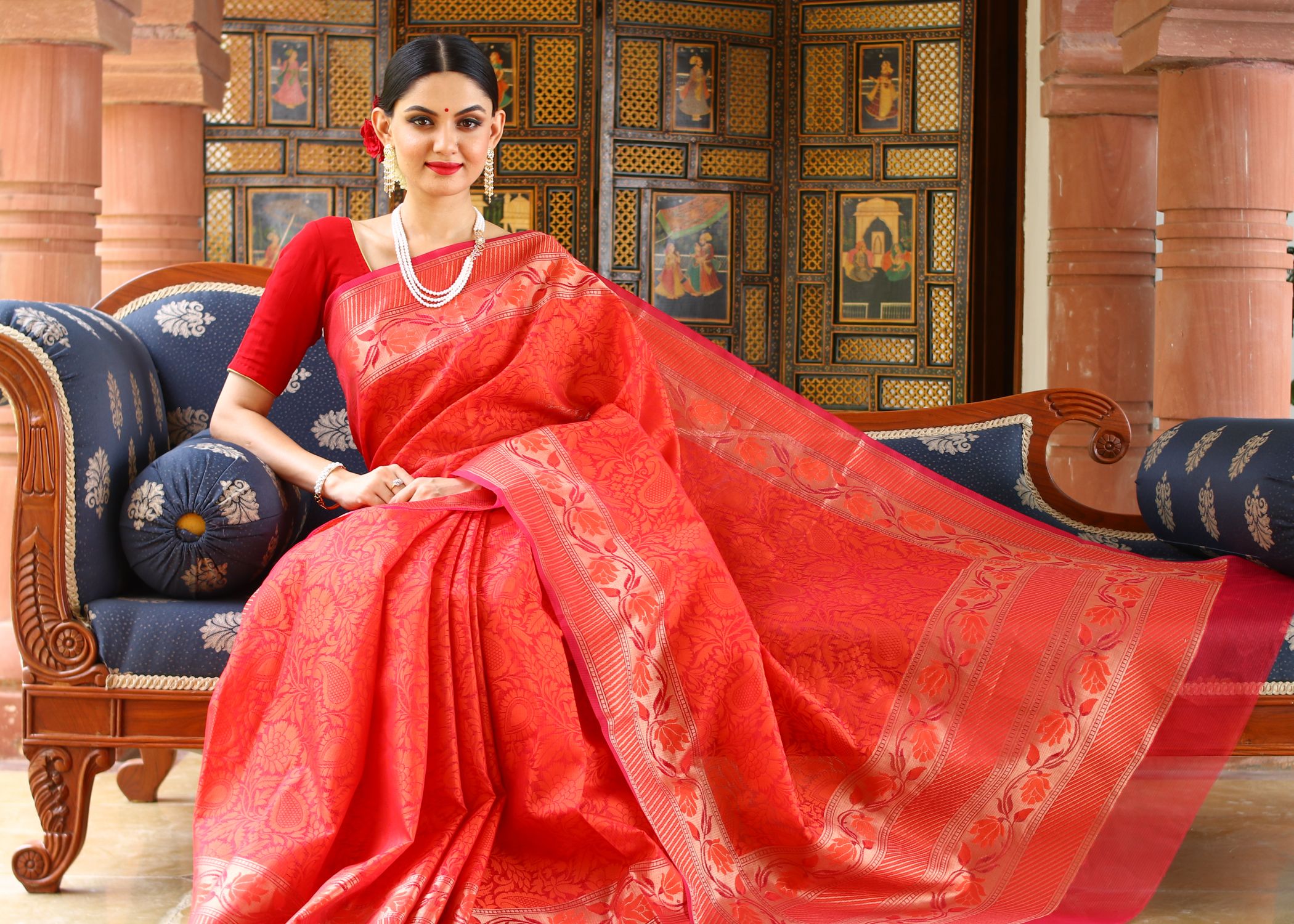 Woman in Traditional Dress Sitting on Sofa · Free Stock Photo