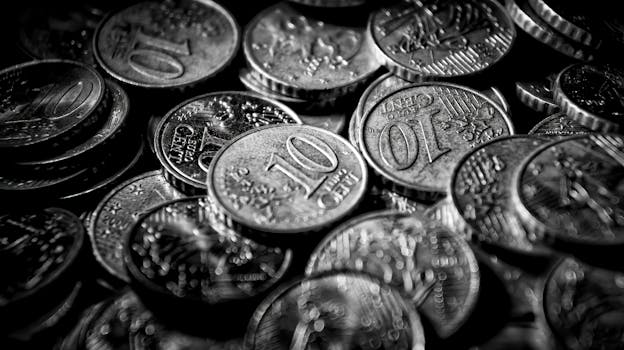 Monochrome close-up of euro coins showcasing currency in a dramatic grayscale tone.