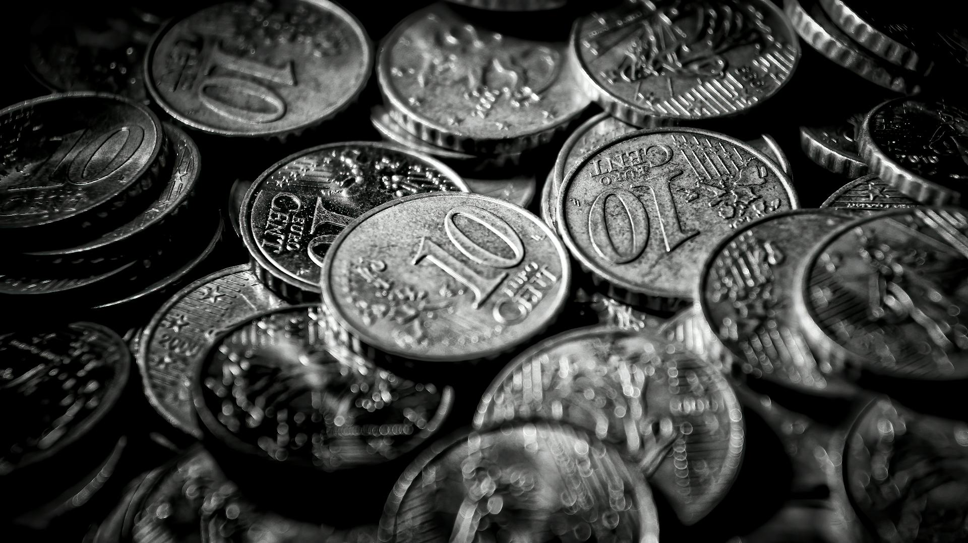 Monochrome close-up of euro coins showcasing currency in a dramatic grayscale tone.