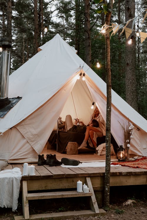 A Couple Sitting Inside a Luxurious Tent in the Forest