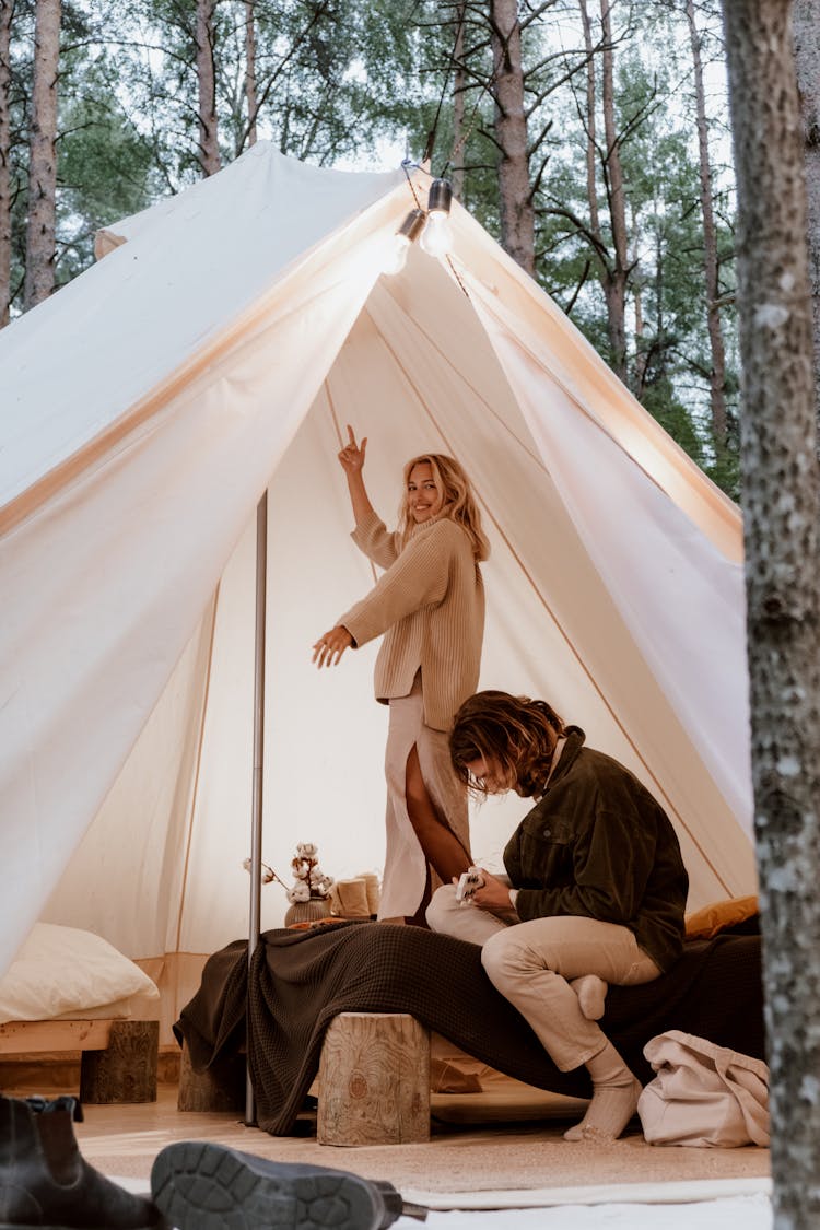 Woman Standing Inside A Tent In The Woods