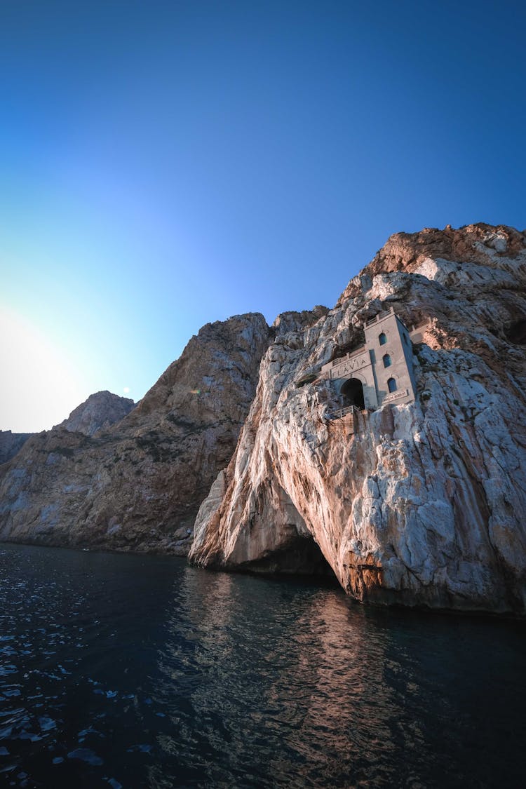 Rocky Seashore With Ancient Gate And Tower