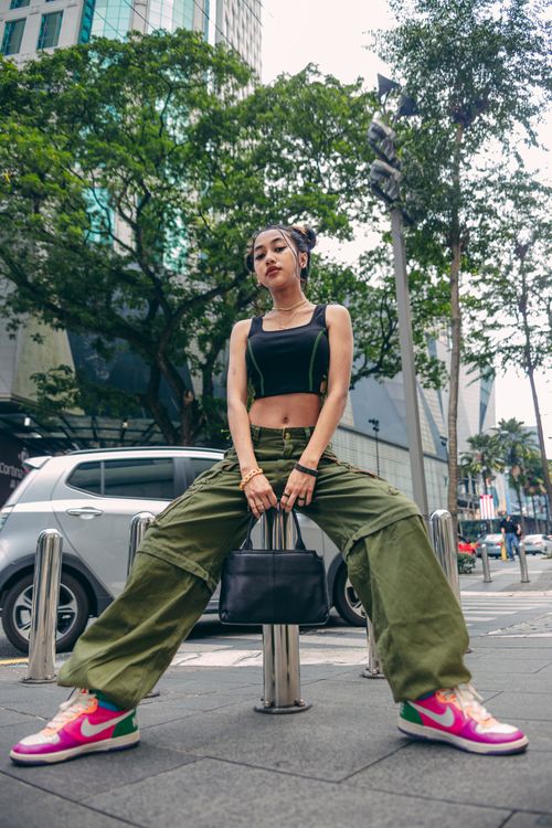 Free Fashionable young woman in cargo pants showcasing urban street style. Stock Photo