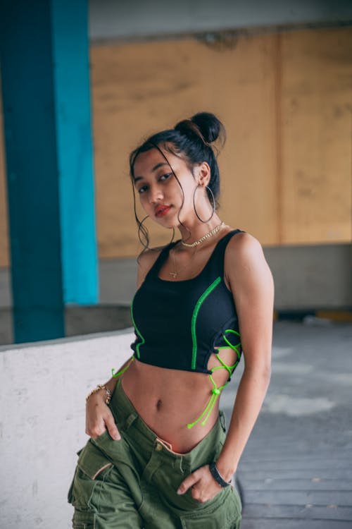 Woman in a Black Crop Top Posing with Her Hands in Her Pockets