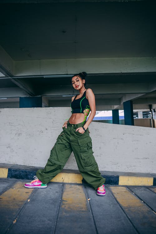 A Woman with Pink Shoes Posing with Her Hands in Her Pockets