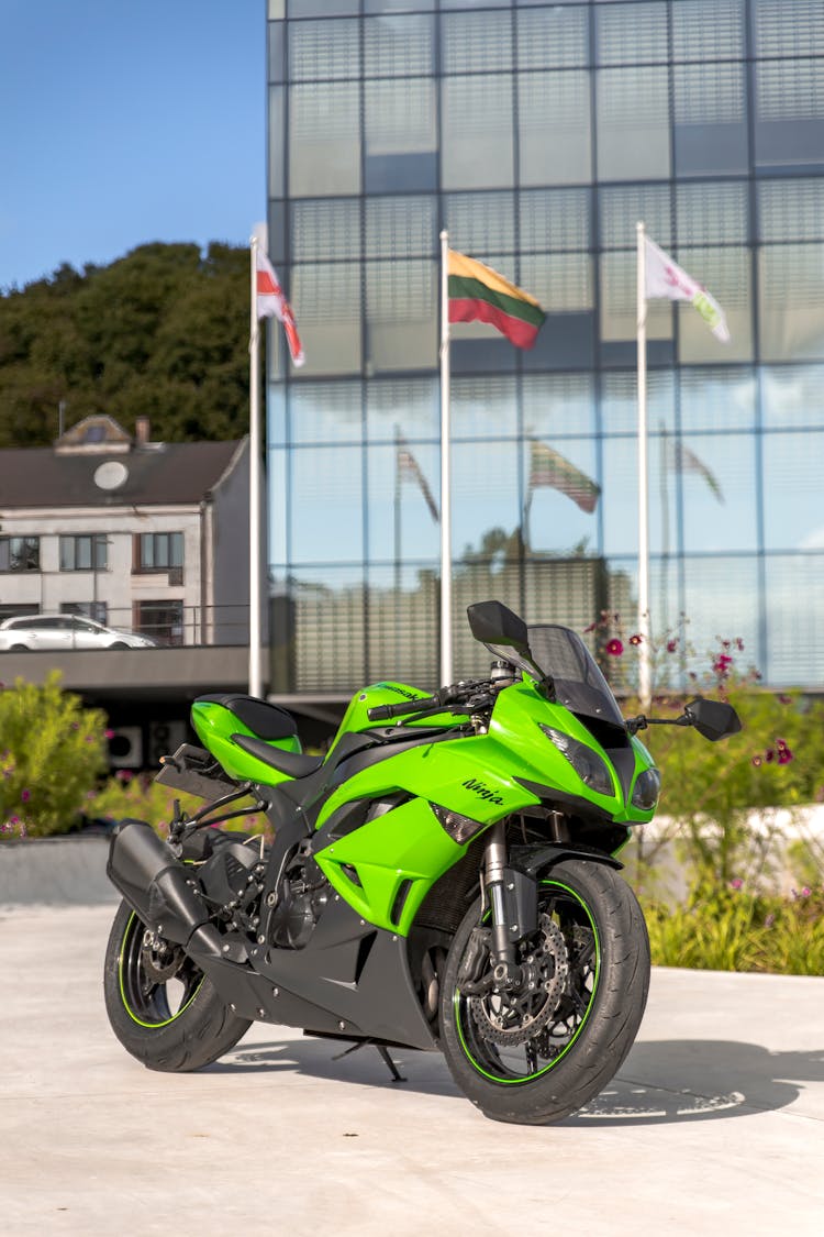 A Green Motorcycle Parked On The Road