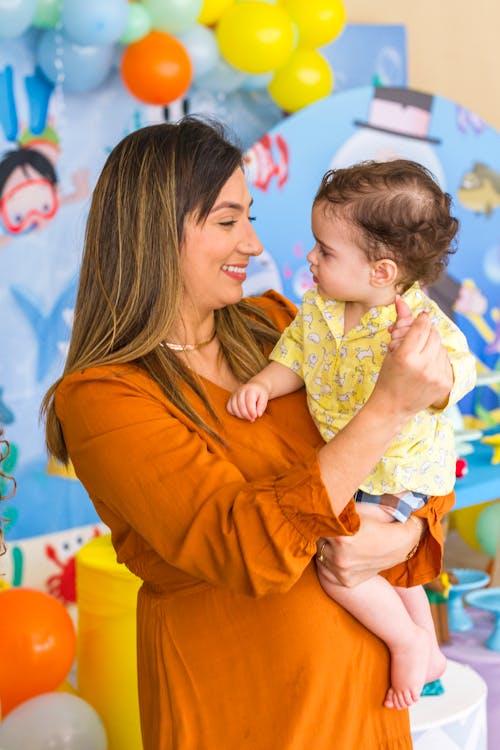 Photo of a Mother and Her Child Looking at Each Other