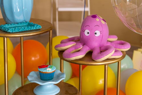 Free Photo of an Octopus Plush Toy Near a Cupcake Stock Photo