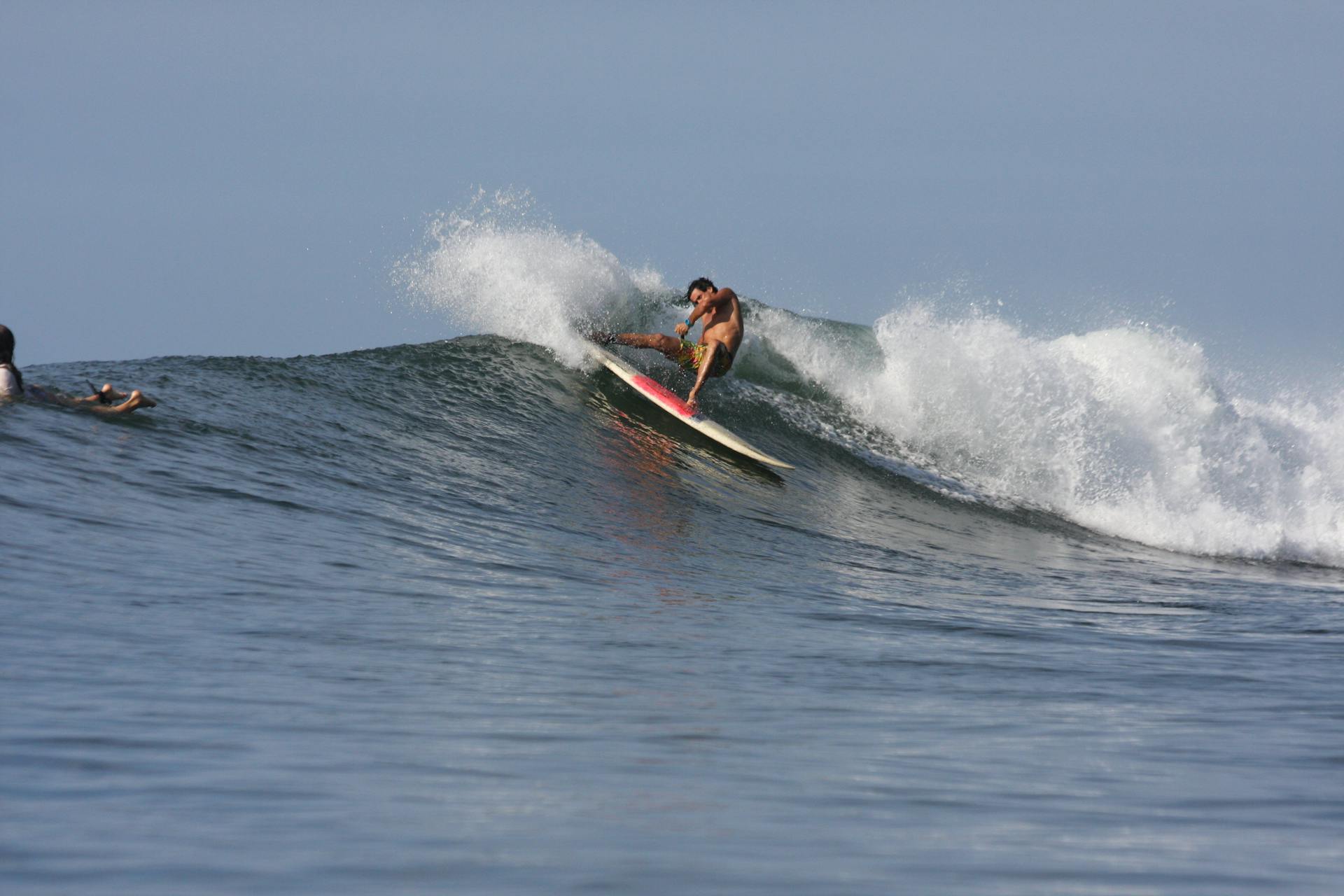 Captivating action shot of a surfer riding the powerful waves of El Salvador's coast.