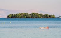 2 People Riding on White and Red Kayak on Blue Sea