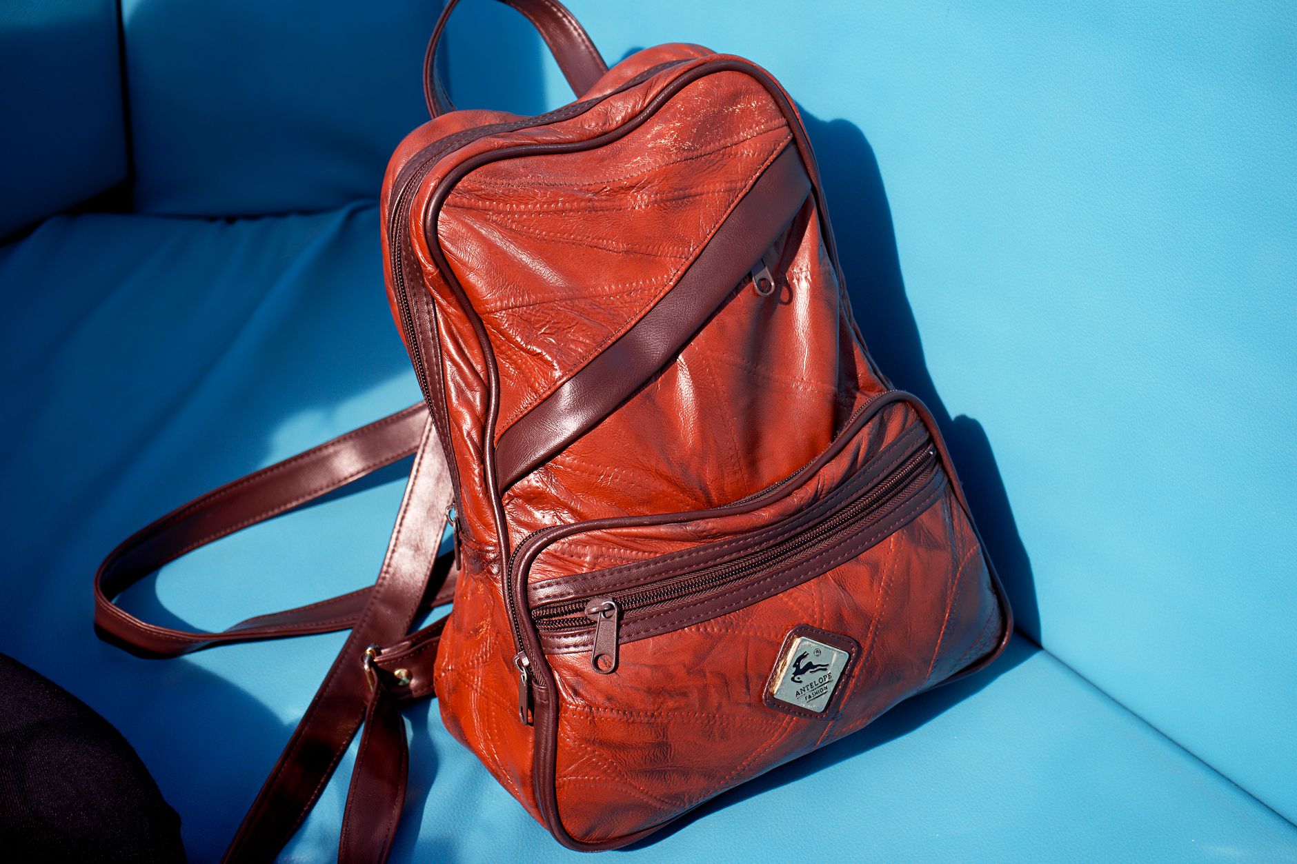 Brown Leather Backpack on a Sofa