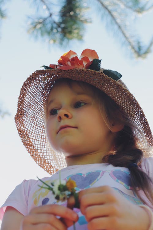 A Girl Waring a Floral Straw Hat