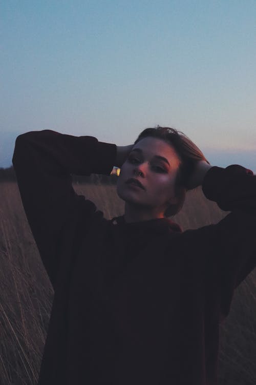 A Woman Pose With Hands on Her Head