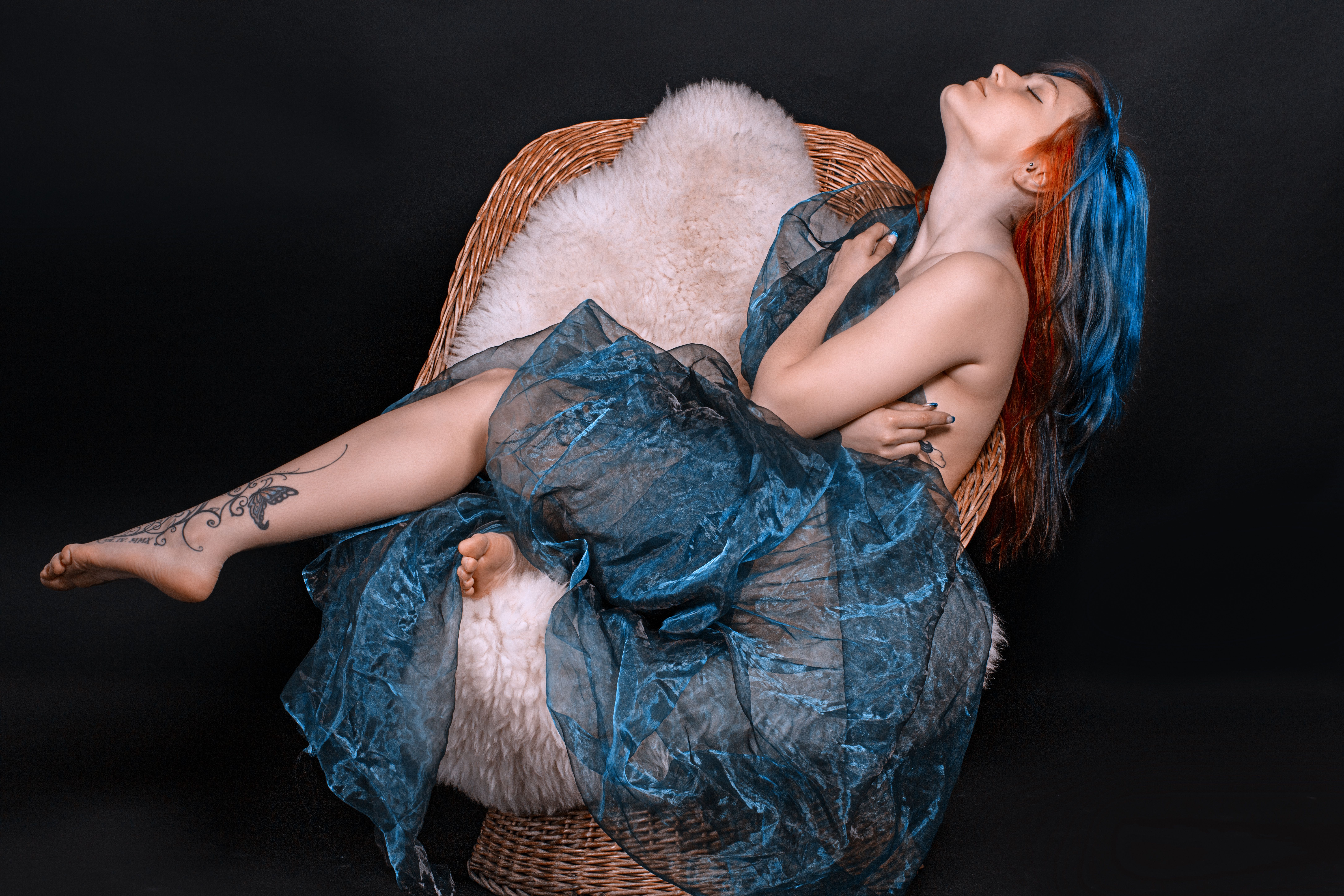 Woman in Blue Dress Sitting on Brown Wicker Chair · Free Stock Photo