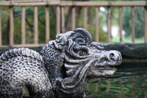 Free Black Concrete Statue on a Pond of Water Stock Photo