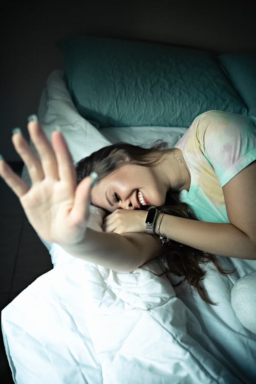 Free Sleepy woman lying in bed in morning Stock Photo