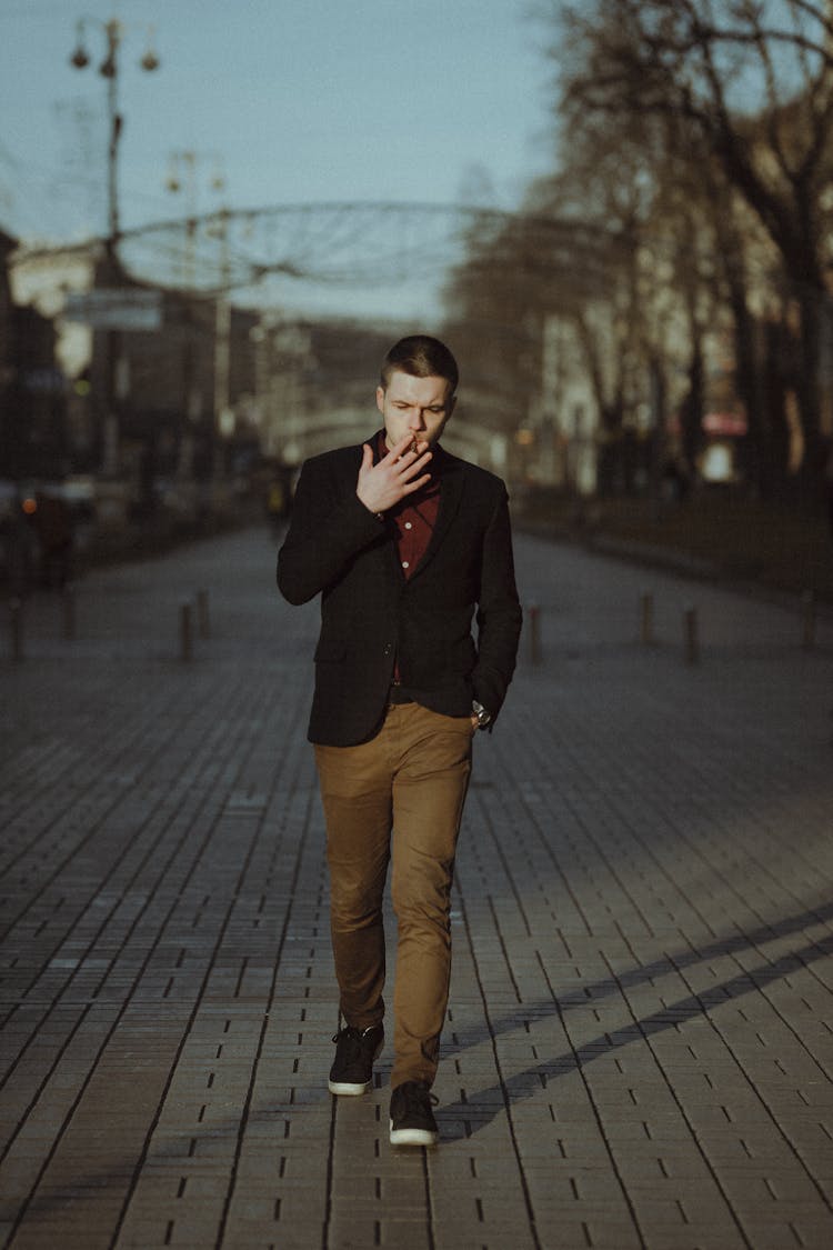 A Man Smoking While Walking 