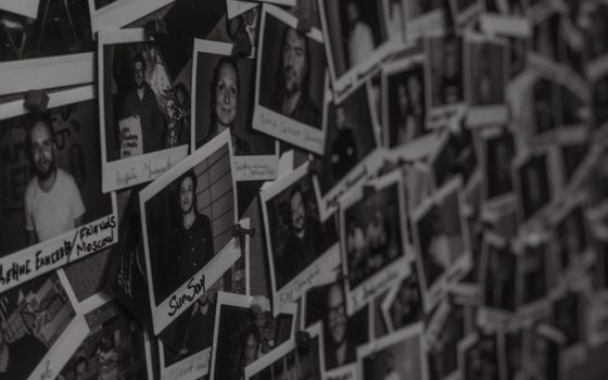 A wall filled with black-and-white Polaroid photos captured in a vintage style in Kyiv, Ukraine.