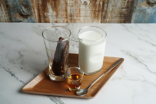 Aesthetic arrangement of milk, coffee, and syrup on a wooden tray, perfect for a morning boost.