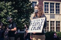 Unrecognizable man with signboard in hands