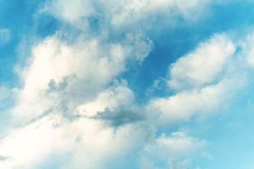 Free Low angle of majestic high blue sky with fluffy clouds in bright sunlight Stock Photo